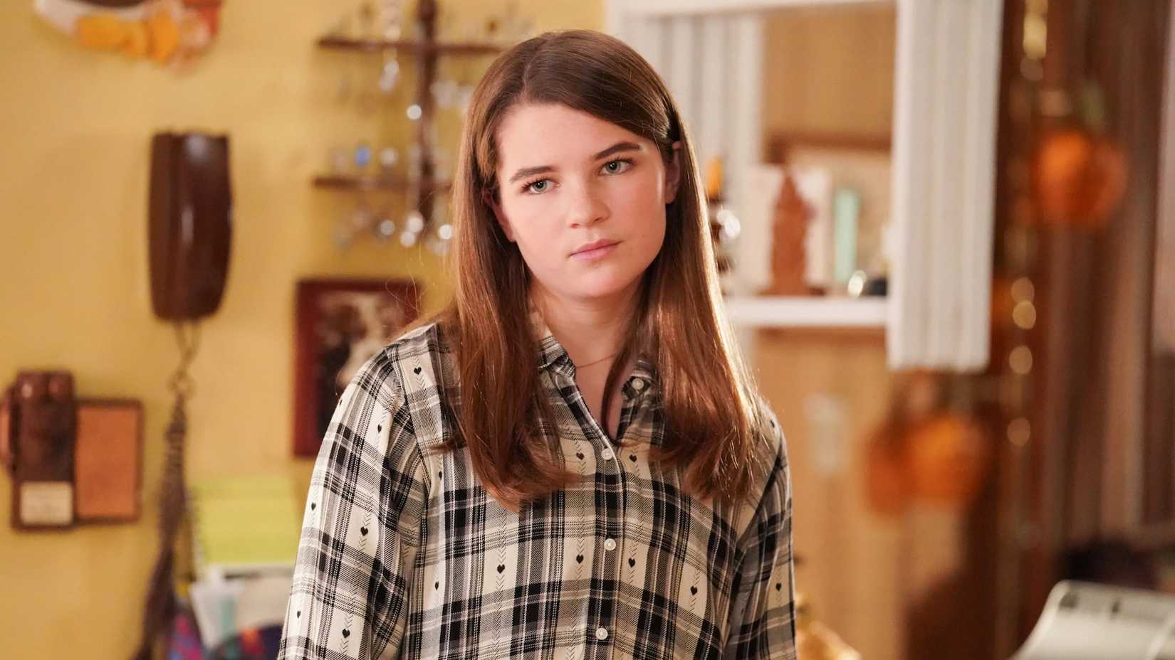 Missy in the Cooper family kitchen wearing a flannel shirt