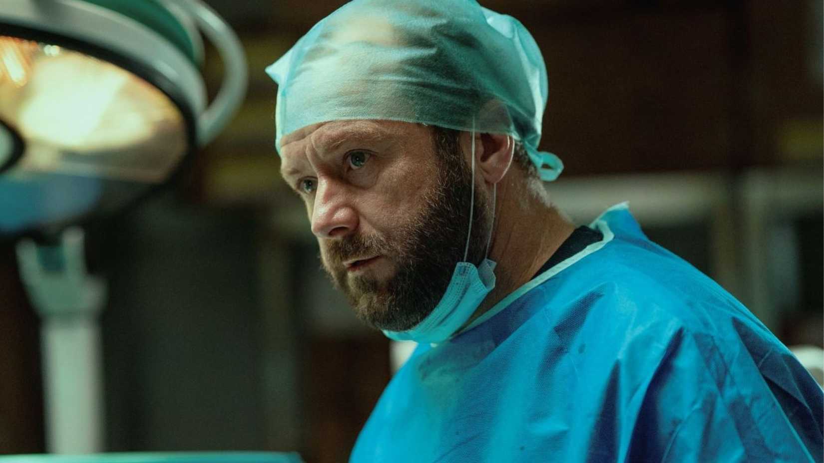 A male surgeon in an operating room