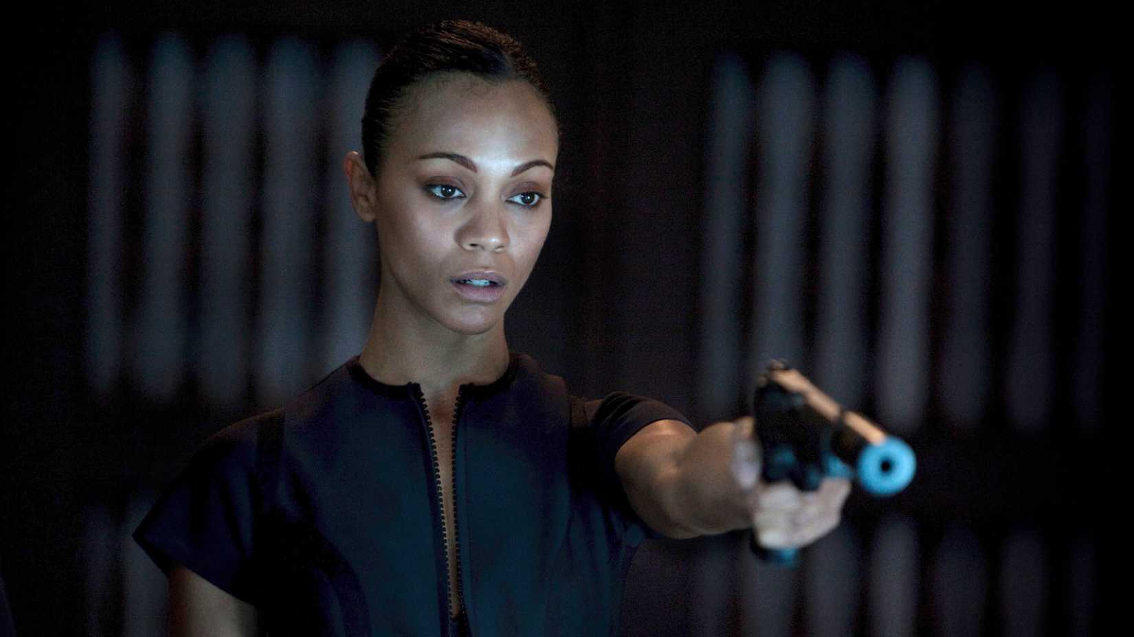 Zoe Saldaña pointing a gun in Colombiana