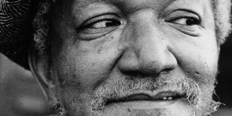 Redd Foxx as Fred smiling in Sanford and Son
