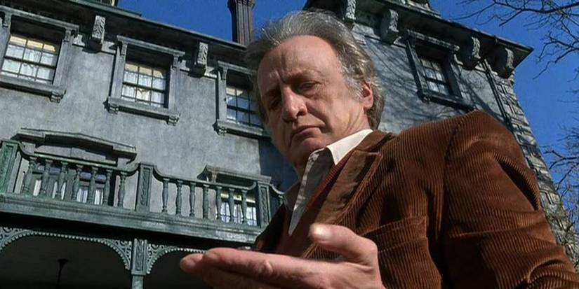 George C. Scott looks down at his hand in The Changeling