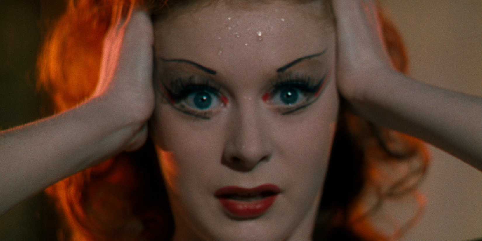 Victoria putting her hands on her temples in The Red Shoes