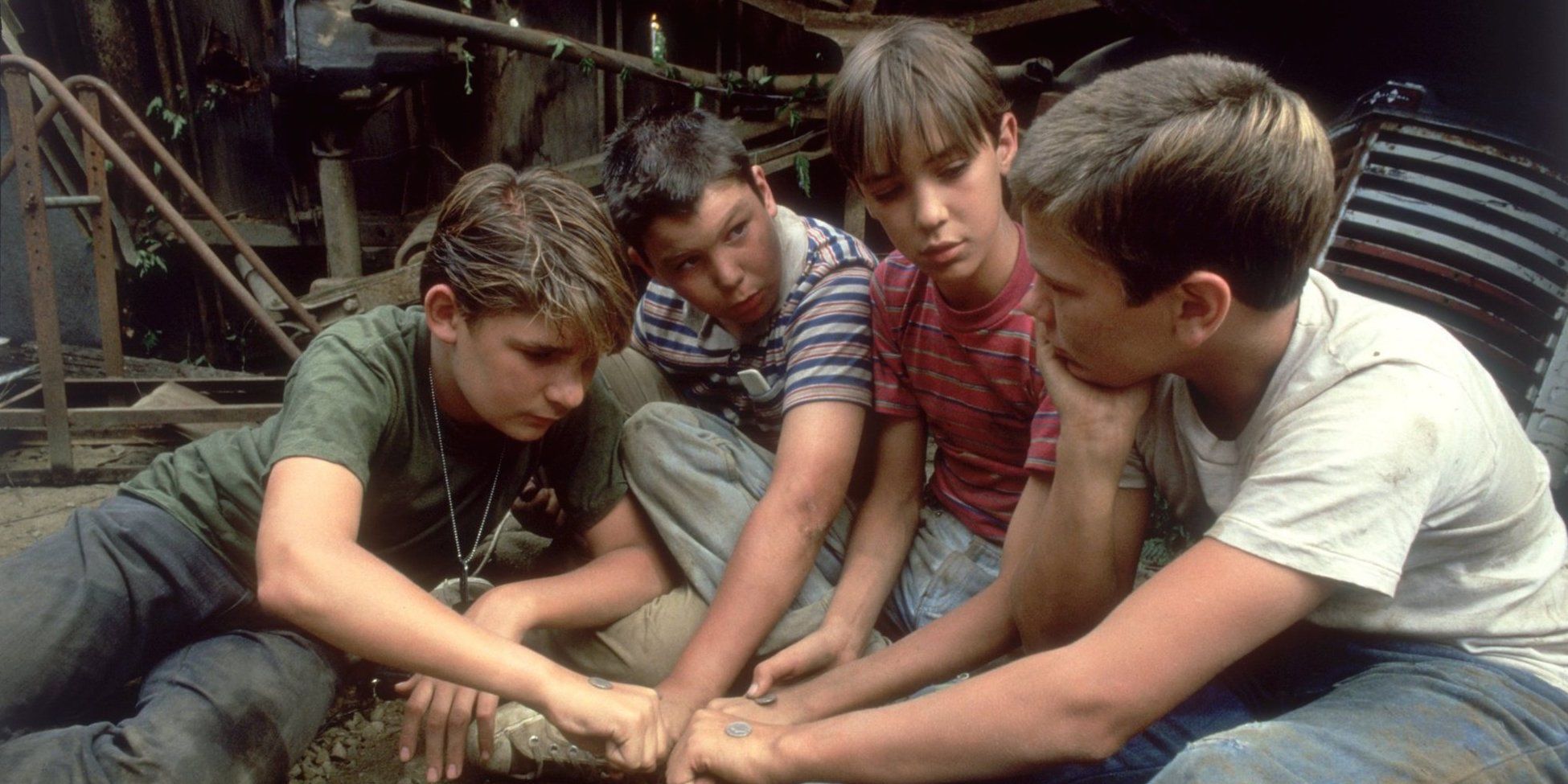 The four boys putting their hands together in Stand By Me