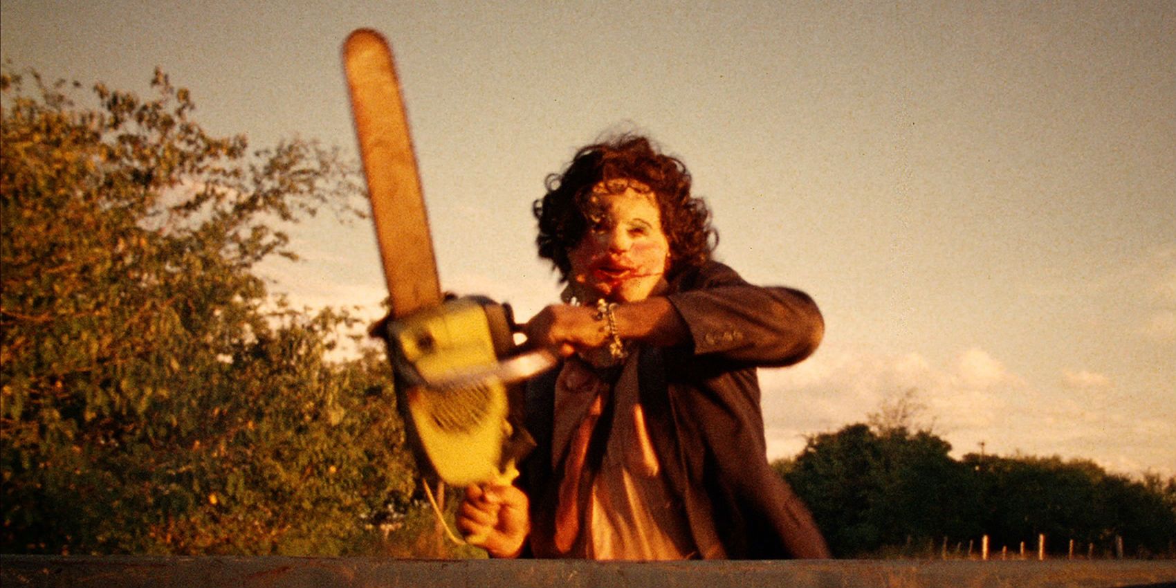 Leatherface holding his chainsaw aloft in The Texas Chainsaw Massacre