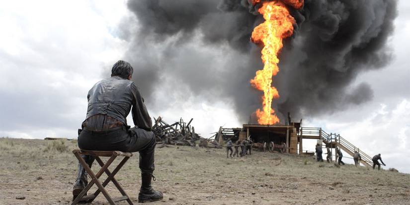 Daniel Day-Lewis in front of a plume of fire in There Will Be Blood