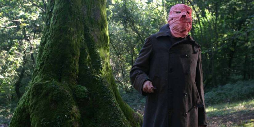 The masked Hector standing in the woods in Timecrimes.