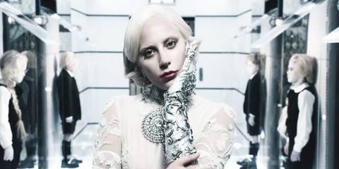 The Countess with vampire kids behind her in American Horror Story: Hotel.