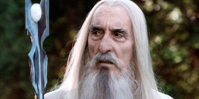 Christopher Lee as Saruman walking with his staff in The Lord Of The Rings.