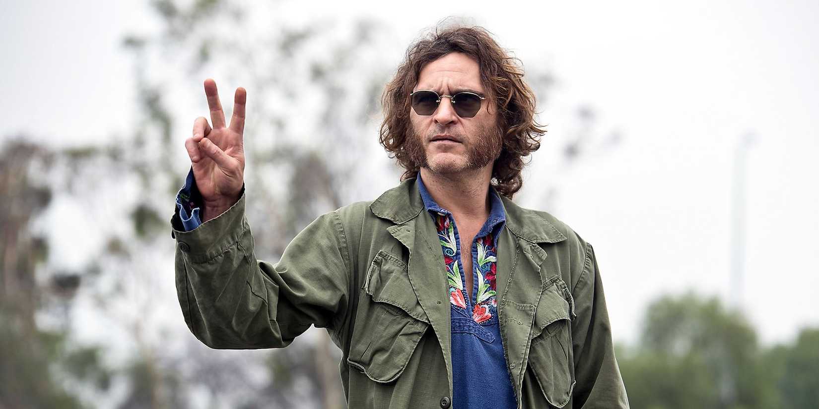 Joaquin Phoenix holding up a peace sign in Inherent Vice