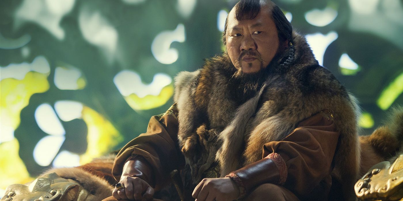 Benedict Wong as Kublai Khan sitting outside by a tree in Marco Polo