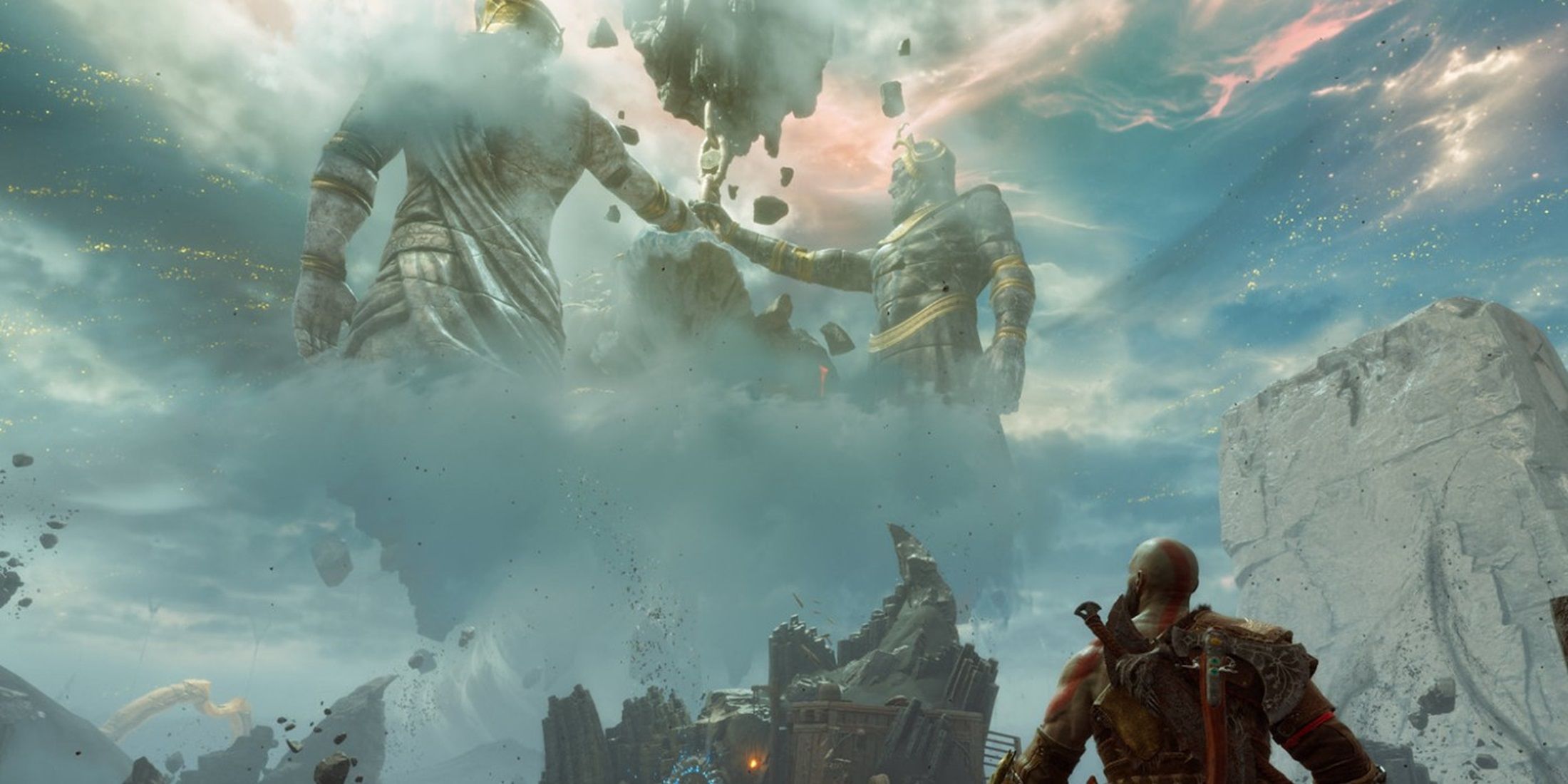 Kratos gazing at colossal statues in a mystical, cloudy landscape in God of War Ragnarok.&nbsp;