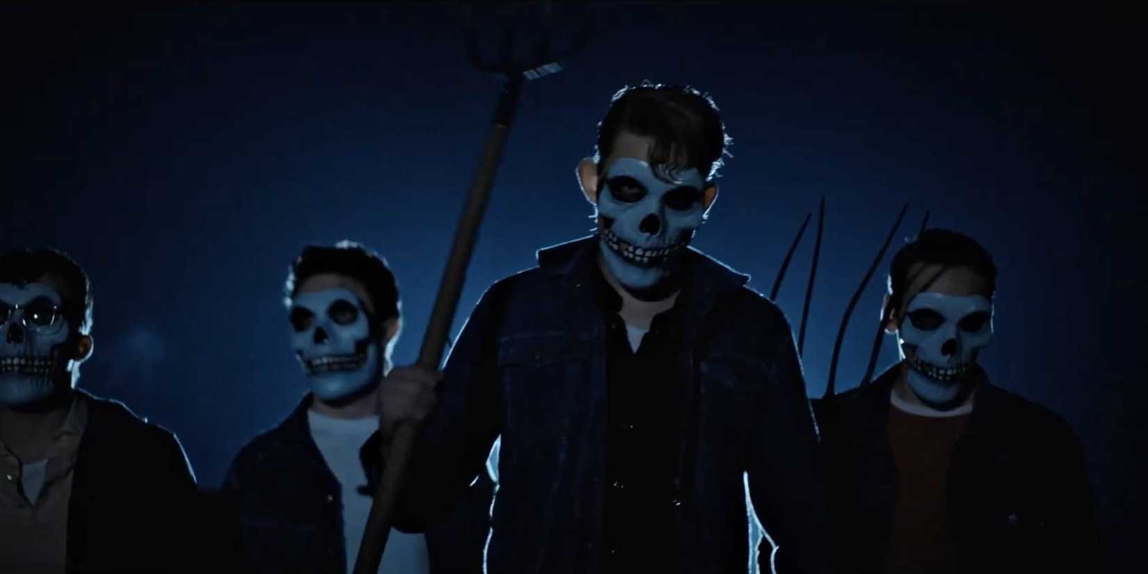 Teenage boys wearing masks and carrying weapons in Dark Harvest