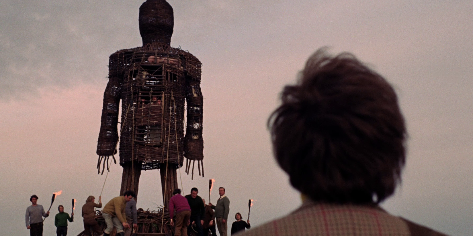 A man looking at a statue in The Wicker Man