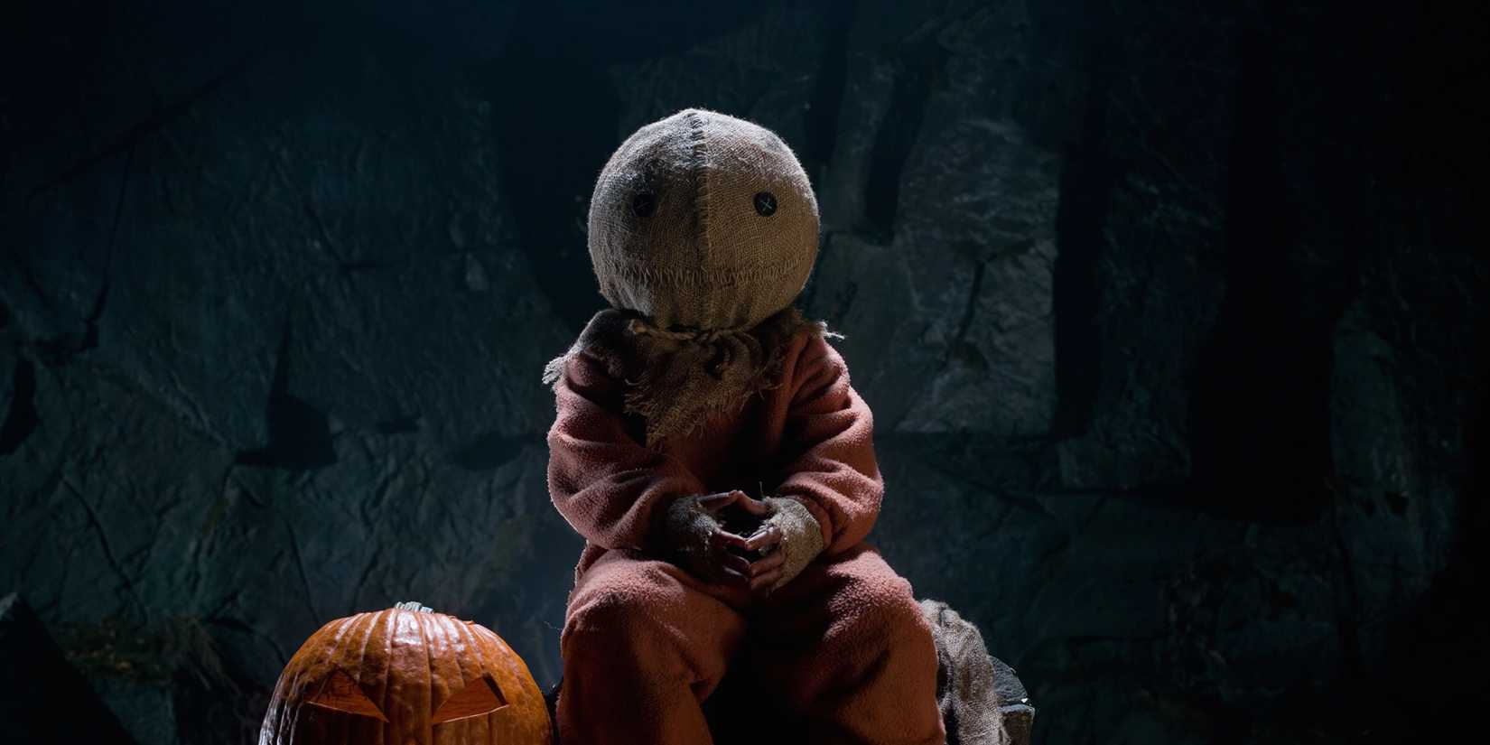 Sam sitting next to a pumpkin in Trick 'R Treat