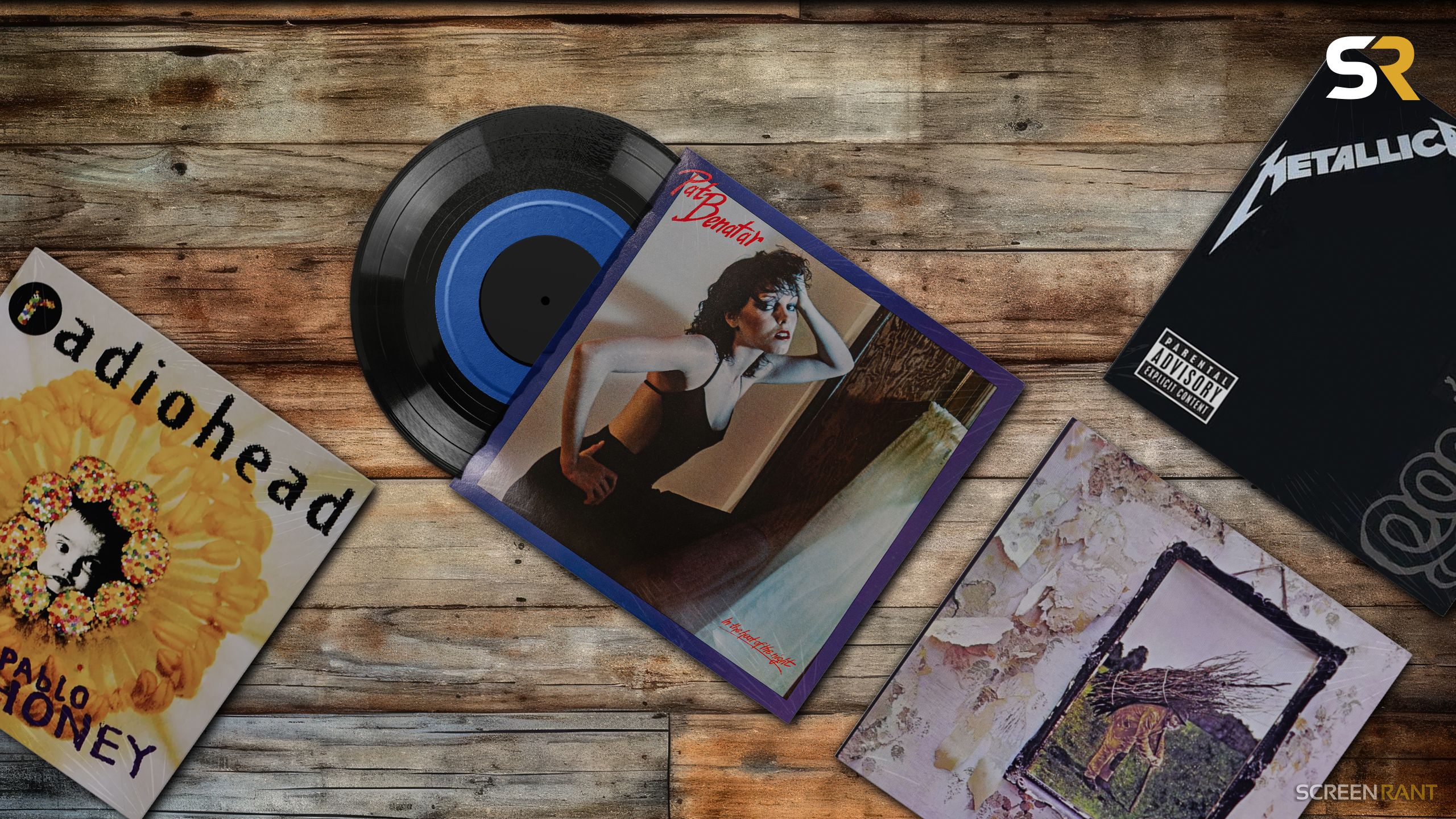 A curated flat-lay of classic rock vinyl records and memorabilia, including Radiohead and Pat Benatar, featuring a 